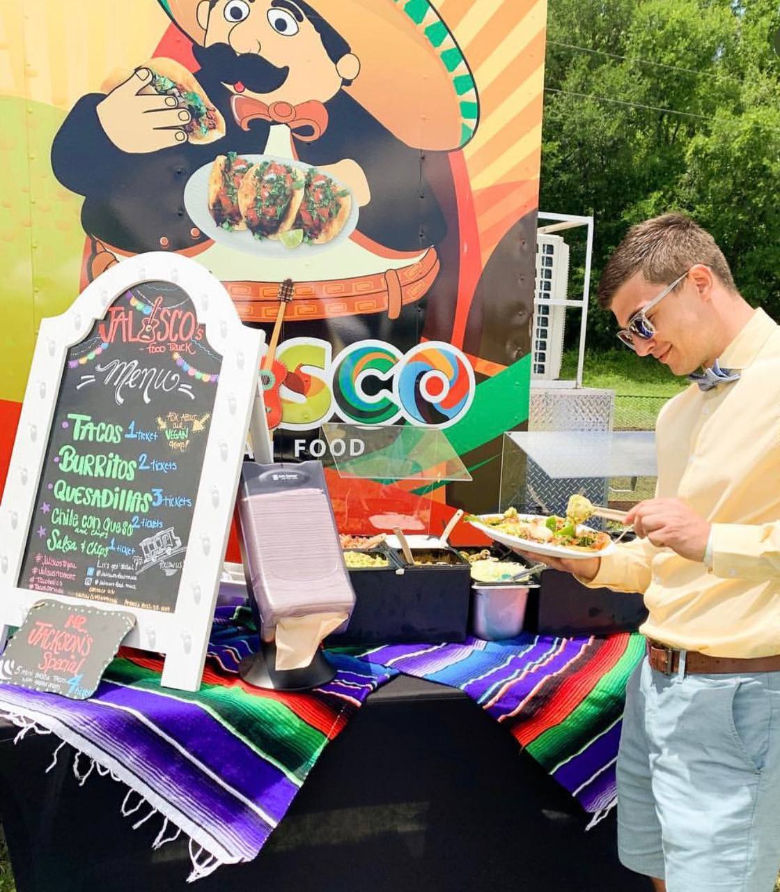 Elegant catering buffet setup at a formal event with chalkboard menu