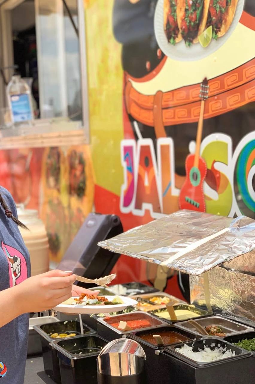 Guest building a plate at a Jalisco Food Truck taco station