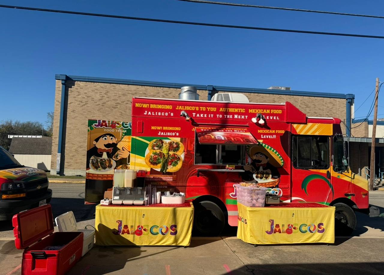 Jalisco Food Truck fully set up with branded tables at a daytime event