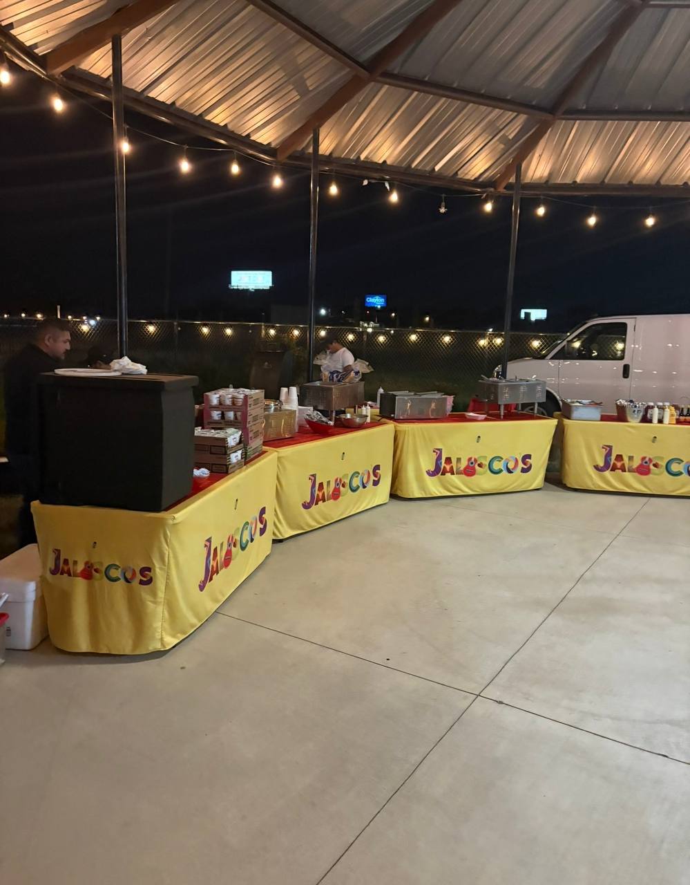 Jalisco Food Truck catering buffet tables under string lights at a night event