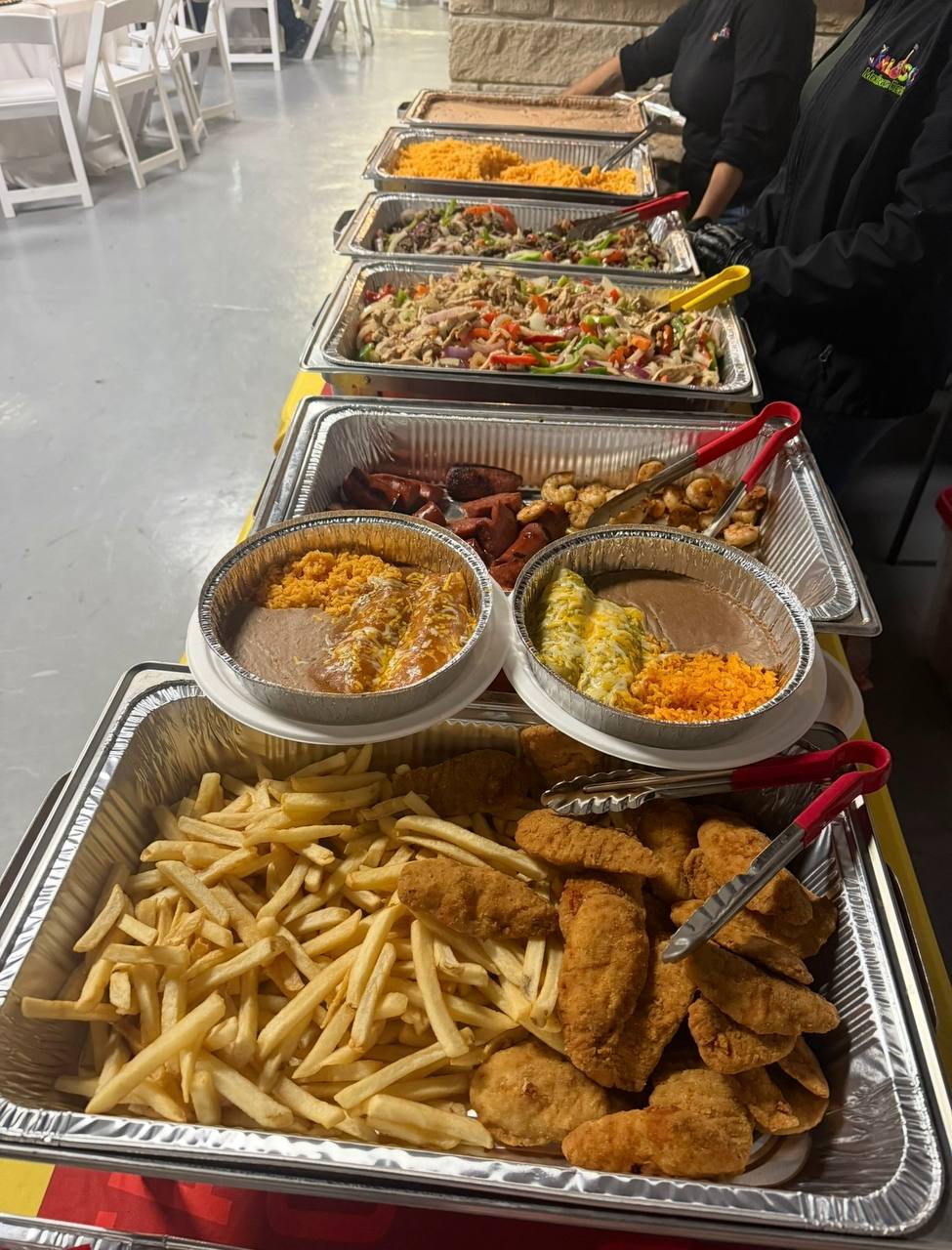 Full catering food spread — fajitas, rice, beans, nuggets and fries at a Jalisco event