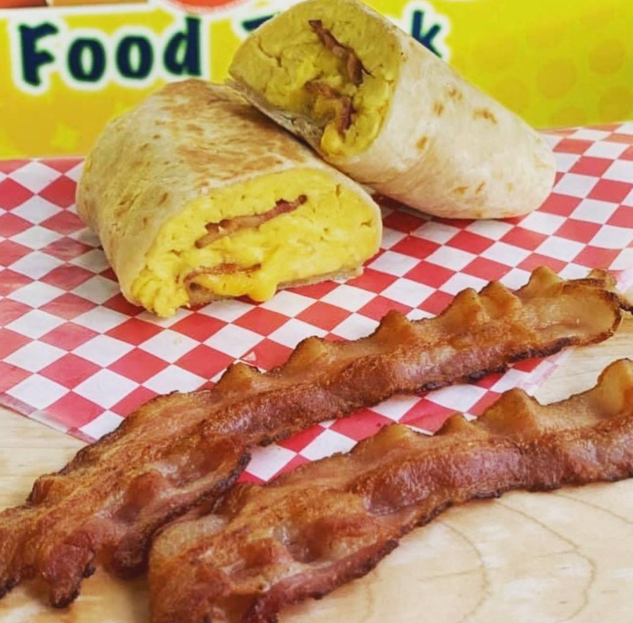 Breakfast burrito cut open with eggs bacon and cheese at Jalisco Food Truck Bastrop TX