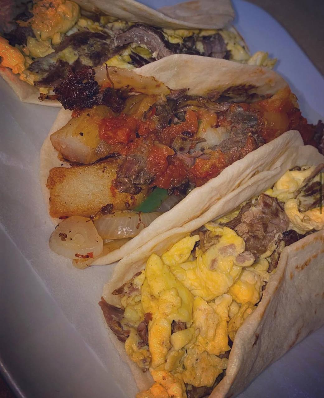 Flour tortilla breakfast tacos with eggs potatoes and salsa at Jalisco Food Truck Bastrop TX