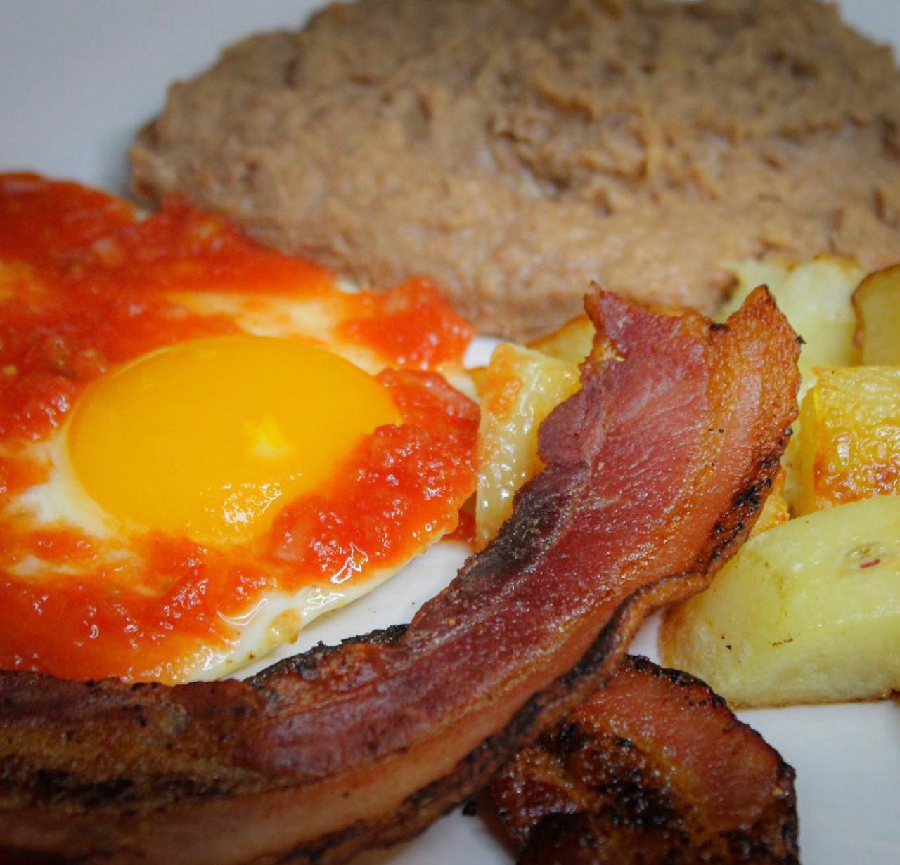 Huevos rancheros with bacon refried beans and potatoes at Jalisco Food Truck Bastrop TX