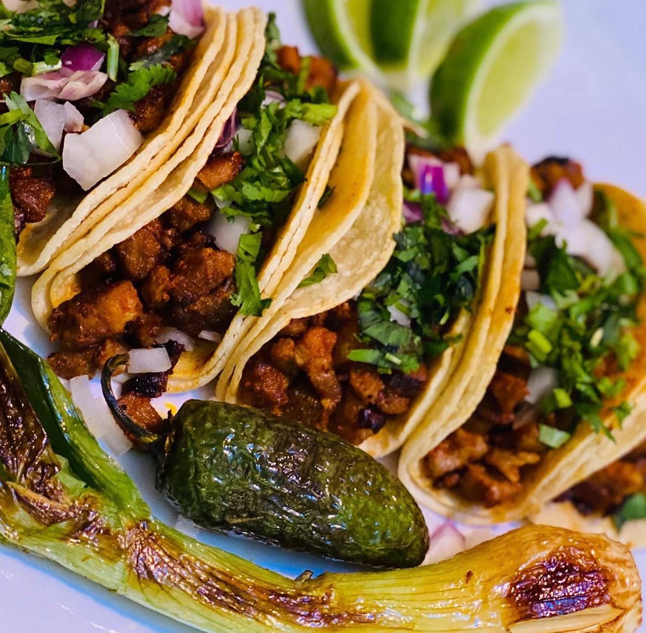 Al pastor tacos with charred jalapeño and green onion at Jalisco Food Truck Bastrop TX