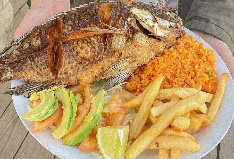 Whole fried fish plate with rice, fries and avocado at Jalisco Food Truck Bastrop TX